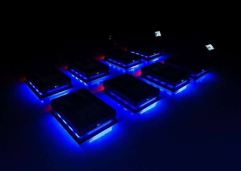 a fleet of Gideon autonomous mobile robots in a dark environment